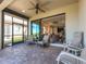 Relaxing screened patio with comfortable seating and a view of the home's interior at 8279 Varenna Dr, Sarasota, FL 34231