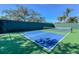 Outdoor pickleball court with green and blue playing surface, ideal for recreational games and fitness at 8279 Varenna Dr, Sarasota, FL 34231