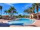 Resort-style pool surrounded by palm trees and lounge chairs, perfect for relaxation and leisure at 8279 Varenna Dr, Sarasota, FL 34231