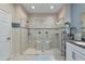 A modern bathroom featuring a large glass enclosed shower with dual shower heads and tiled surround at 854 Rosemary Cir, Bradenton, FL 34212