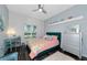 A charming bedroom featuring dark wood floors, a ceiling fan, and plenty of natural light at 854 Rosemary Cir, Bradenton, FL 34212