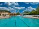 Large community pool with multiple lanes for swimming, a splash pad, and a clubhouse at 854 Rosemary Cir, Bradenton, FL 34212