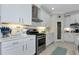 Bright kitchen with white cabinets, stainless steel appliances, and subway tile backsplash at 854 Rosemary Cir, Bradenton, FL 34212