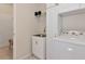 Laundry room featuring a utility sink, overhead storage, and a front-loading washing machine at 854 Rosemary Cir, Bradenton, FL 34212