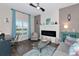 Living room with fireplace, light teal accents and wood floors at 854 Rosemary Cir, Bradenton, FL 34212