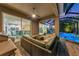 Relaxing covered patio featuring comfortable seating, ceiling fan, and a view of the screened pool at 854 Rosemary Cir, Bradenton, FL 34212