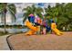 Fun playground area with colorful slides and climbing structures by the lake at 854 Rosemary Cir, Bradenton, FL 34212