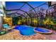 Beautiful screened-in pool and spa area with lush landscaping and ample seating at 854 Rosemary Cir, Bradenton, FL 34212