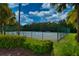 Well-maintained tennis court surrounded by lush greenery, perfect for sports enthusiasts at 854 Rosemary Cir, Bradenton, FL 34212