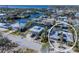 Aerial view of waterfront home with solar panels, pool, and boat dock at 903 20Th W Ave, Palmetto, FL 34221