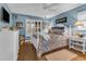 Bedroom with white furniture, blue and beige bedding, and hardwood floors at 903 20Th W Ave, Palmetto, FL 34221