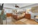 Main bedroom with wood flooring, a ceiling fan, and a walk-in closet at 903 20Th W Ave, Palmetto, FL 34221