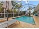 Screened pool with lounge chairs and lush landscaping at 903 20Th W Ave, Palmetto, FL 34221