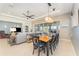 Elegant dining room with a wood table and chairs, open to the living room at 108 Savona Ct, North Venice, FL 34275