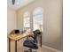 Spacious home office with a large desk and comfortable chair, plus windows with blinds at 108 Savona Ct, North Venice, FL 34275