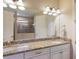 Double vanity bathroom with granite countertop and walk-in shower at 11136 Shearwater Ct, Sarasota, FL 34238