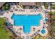 Aerial view of community pool with lounge chairs at 11136 Shearwater Ct, Sarasota, FL 34238