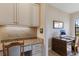 Kitchen features granite countertops and white cabinetry with a built-in workspace at 11136 Shearwater Ct, Sarasota, FL 34238