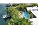 Aerial view showing home, pool, boat dock, and lush landscaping at 117 S Polk Dr, Sarasota, FL 34236