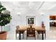 Bright dining room with a large wooden table and mid-century chairs at 117 S Polk Dr, Sarasota, FL 34236