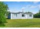 Newly built home with a contemporary design, featuring light gray siding and a grassy yard at 1226 Coral Ridge Dr, Punta Gorda, FL 33950