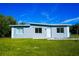 Newly renovated home with a modern design, featuring a light gray exterior and a well-manicured lawn at 1226 Coral Ridge Dr, Punta Gorda, FL 33950