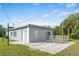 Gray house with a patio and surrounding lawn at 1226 Coral Ridge Dr, Punta Gorda, FL 33950