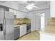 Kitchen features stainless steel appliances and white cabinets at 1226 Coral Ridge Dr, Punta Gorda, FL 33950