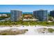 Aerial view of resort with beach, pool and tennis courts at 1281 Gulf Of Mexico Dr # 404, Longboat Key, FL 34228