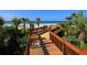 Wooden boardwalk to beach with grilling area, lush vegetation at 1281 Gulf Of Mexico Dr # 404, Longboat Key, FL 34228