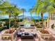 Tropical courtyard with seating, fountain, and ocean view at 1281 Gulf Of Mexico Dr # 404, Longboat Key, FL 34228