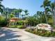 Gated entrance to community, lush landscaping, and signage at 1281 Gulf Of Mexico Dr # 404, Longboat Key, FL 34228