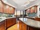 Modern kitchen featuring granite countertops and sunset views at 1281 Gulf Of Mexico Dr # 404, Longboat Key, FL 34228