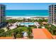 Resort-style pool area with ocean views and lush landscaping at 1281 Gulf Of Mexico Dr # 404, Longboat Key, FL 34228