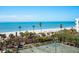 Oceanfront tennis court with palm trees and beautiful beach views at 1281 Gulf Of Mexico Dr # 404, Longboat Key, FL 34228