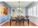 Formal dining room with hardwood floors, chandelier, and large windows at 12904 49Th E Ln, Parrish, FL 34219