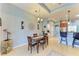 Bright dining area with a wooden table and chairs, adjacent to the kitchen at 12904 49Th E Ln, Parrish, FL 34219