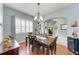 Formal dining room with hardwood floors, chandelier, and large windows at 12904 49Th E Ln, Parrish, FL 34219