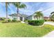 Two-story home with a landscaped lawn and palm trees at 12904 49Th E Ln, Parrish, FL 34219