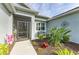 Front entrance with a screened porch and landscaping at 12904 49Th E Ln, Parrish, FL 34219