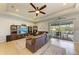 Spacious living room featuring leather furniture and sliding glass doors leading to the backyard at 12904 49Th E Ln, Parrish, FL 34219