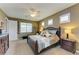 Bright main bedroom with a king bed and large window at 12904 49Th E Ln, Parrish, FL 34219