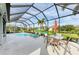 Screened pool and patio with seating and umbrella at 12904 49Th E Ln, Parrish, FL 34219