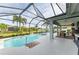 Relaxing pool area with covered patio, seating, and fountain at 12904 49Th E Ln, Parrish, FL 34219