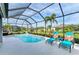 Inviting pool with screened enclosure and lounge chairs at 12904 49Th E Ln, Parrish, FL 34219