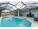 Enclosed pool and patio area with seating and grill at 12904 49Th E Ln, Parrish, FL 34219