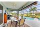 Covered patio with pool view, table, and grill at 12904 49Th E Ln, Parrish, FL 34219