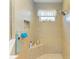 Large walk-in shower with built-in seat and window at 12904 49Th E Ln, Parrish, FL 34219