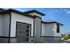 Modern home exterior with dark trim, wood garage door, and tile accents at 1327 Wesley Dr, Punta Gorda, FL 33950