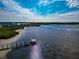 Aerial view of waterfront property with a private dock and nearby homes at 1341 Perico Point Cir # 116, Bradenton, FL 34209